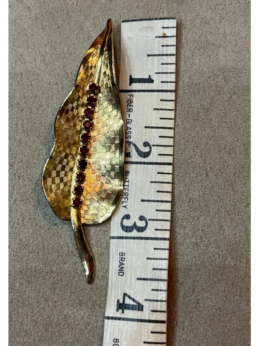 Vintage 60s Etched Gold Tone Red Rhinestone Curved Leaf Pin Brooch MCM